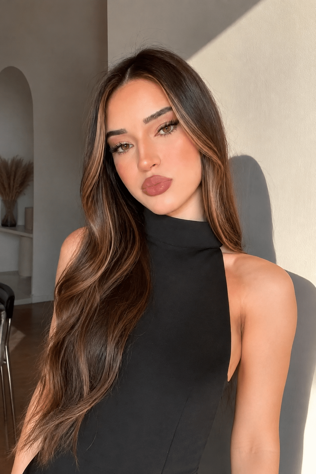 Elegant Brunette Glam With Soft Waves and Face-Framing Highlights 3 elegant brunette glam